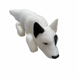 3D-printed German Shorthair Pointer figurine in white with black ears and nose, lying down on a smooth surface.