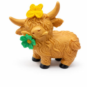 3D printed Highland cow figurine with bow and flower displayed on a window shelf in farmhouse style decor